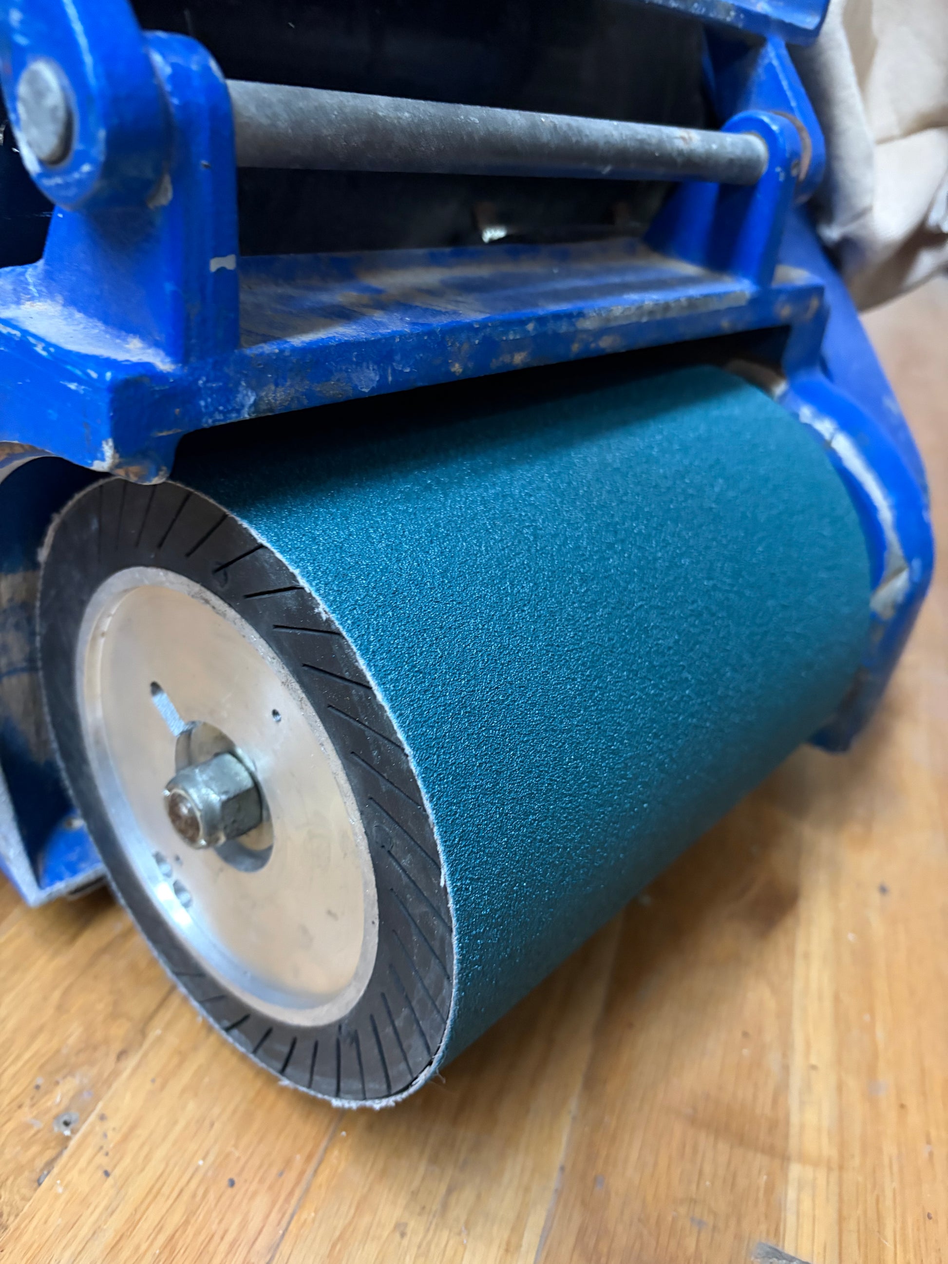 8x19 zirconia sanding belt installed on a Clarke EZ-8 drum floor sander sanding a hardwood floor.